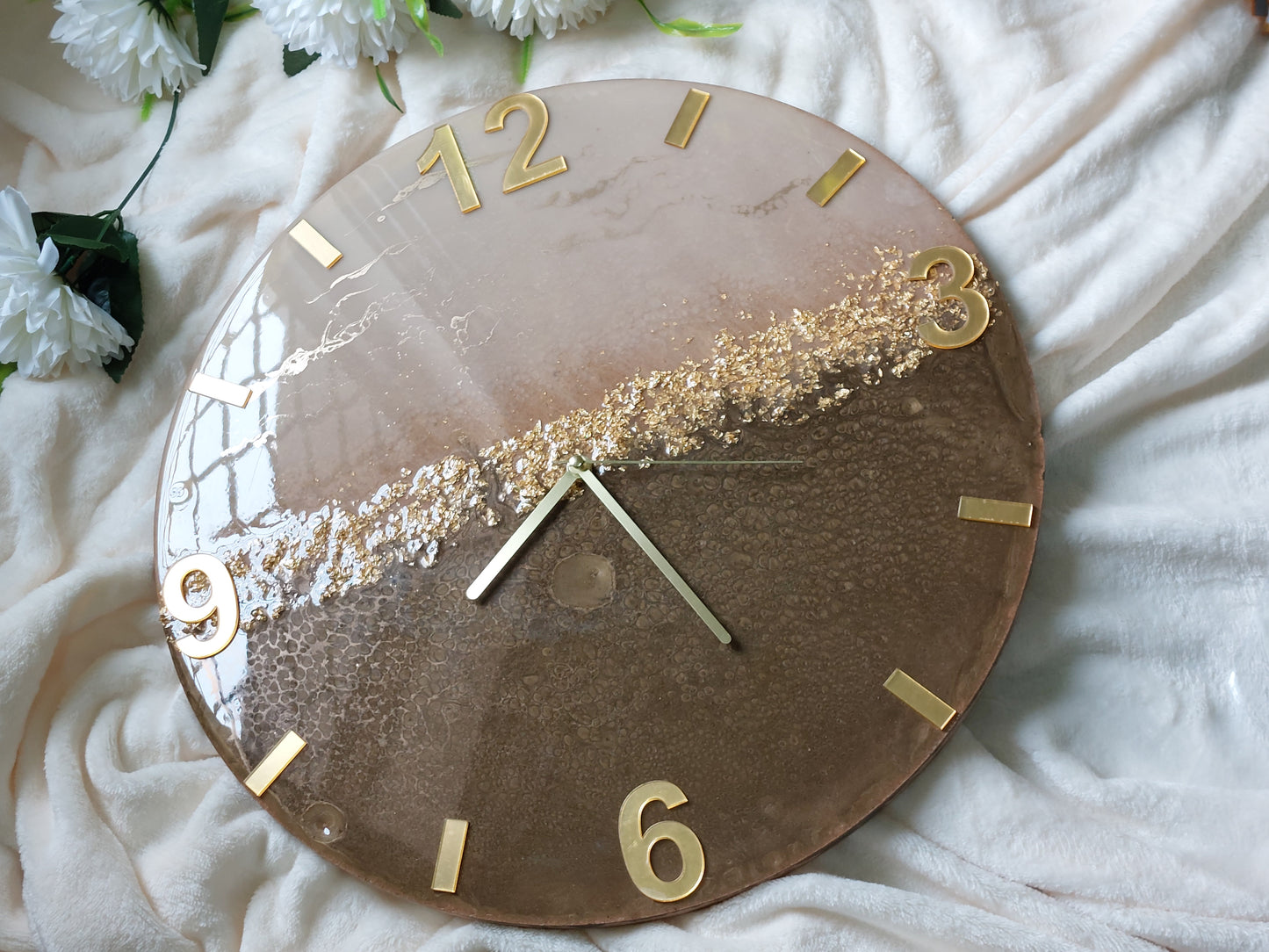 A clever and elegant layout combines numbers and rectangular lines crafted from mirrored acrylic in a lustrous gold or silver finish.  Only the key numerals are positioned to clearly display the time at the 12, 3, 6, and 9 o'clock positions