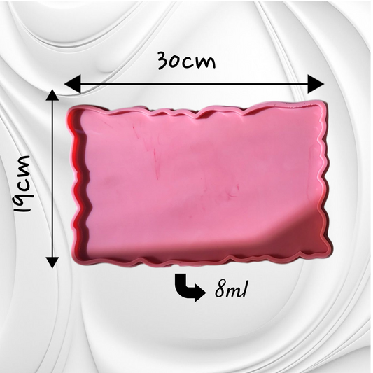 This silicone mold features a rectangular shape with irregular, serrated edges, giving the cast piece a natural appearance resembling gemstones or raw marble. It is suitable for resin, wax, or ceramics. Dimensions: 30 x 19 cm, Depth: 8 mm