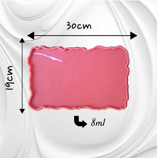 This silicone mold features a rectangular shape with irregular, serrated edges, giving the cast piece a natural appearance resembling gemstones or raw marble. It is suitable for resin, wax, or ceramics. Dimensions: 30 x 19 cm, Depth: 8 mm