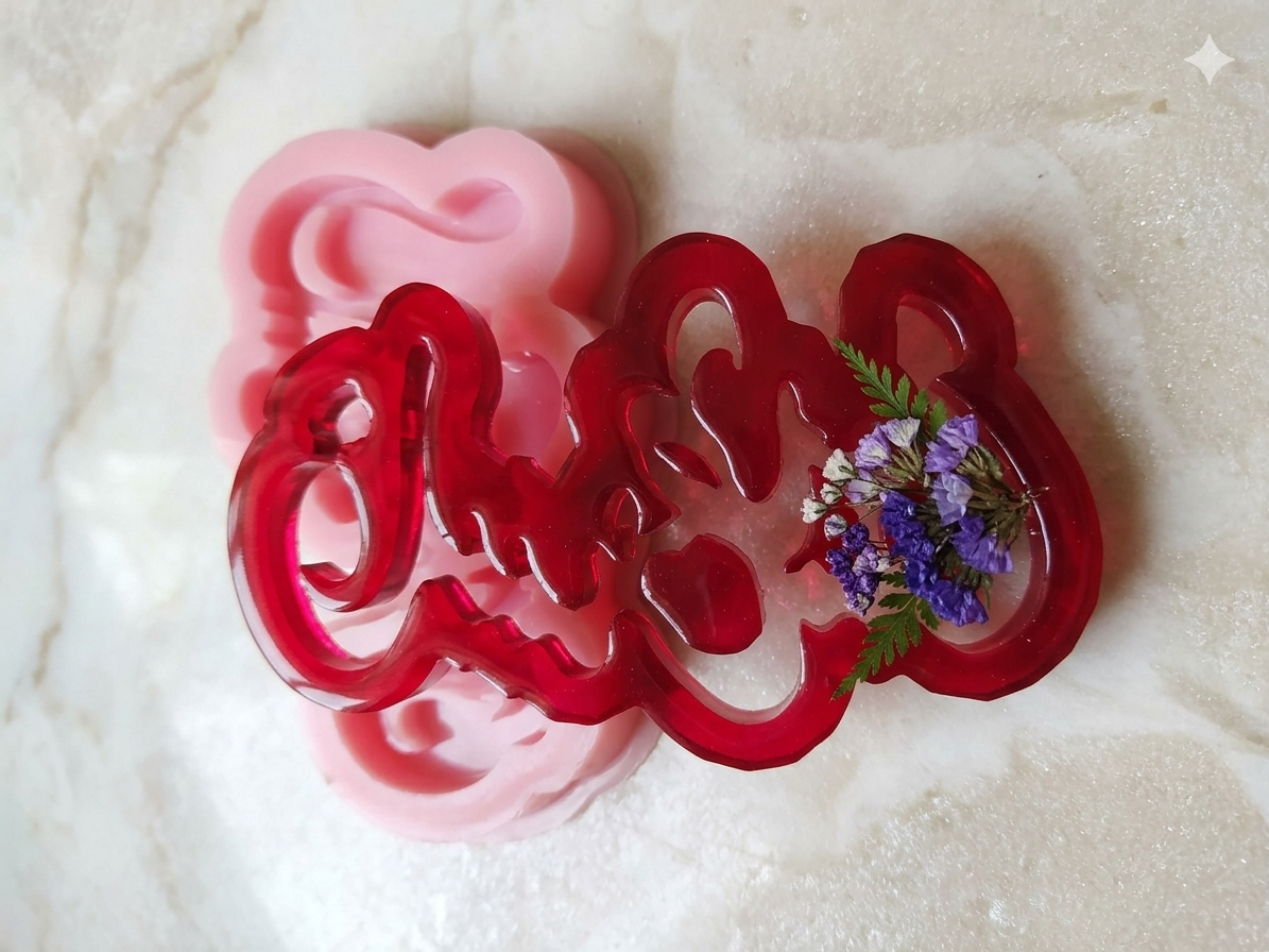 A shiny pink silicone mold forming the word Palestine, composed of interlocking engraved letters.