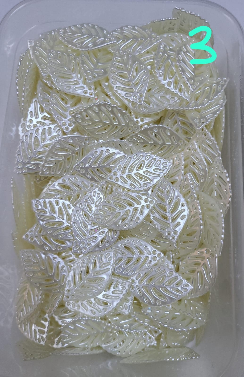 These hollow, leaf-shaped pearl fillers and embellishments are very delicate and popular in crafts. They are used inside clear resin molds or glued onto the surfaces of incense burners, trays, and jewelry boxes to give them an elegant and subtle touch