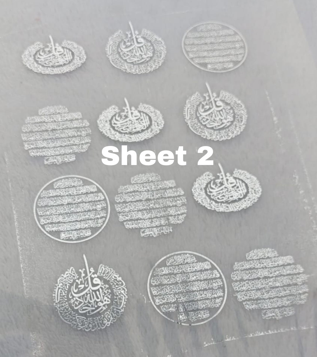 Transparent printed paper or stickers containing Quranic verses, supplications, and prayers. This type of repeated text is used to be included inside resin molds, or to be glued onto car pendants and medals as handicrafts