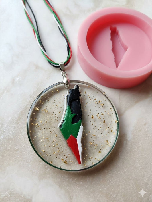 A round silicone mold with a raised Palestinian flag, suitable for making resin, candle, or concrete pendants, as well as scented soaps and fragrant mastic.