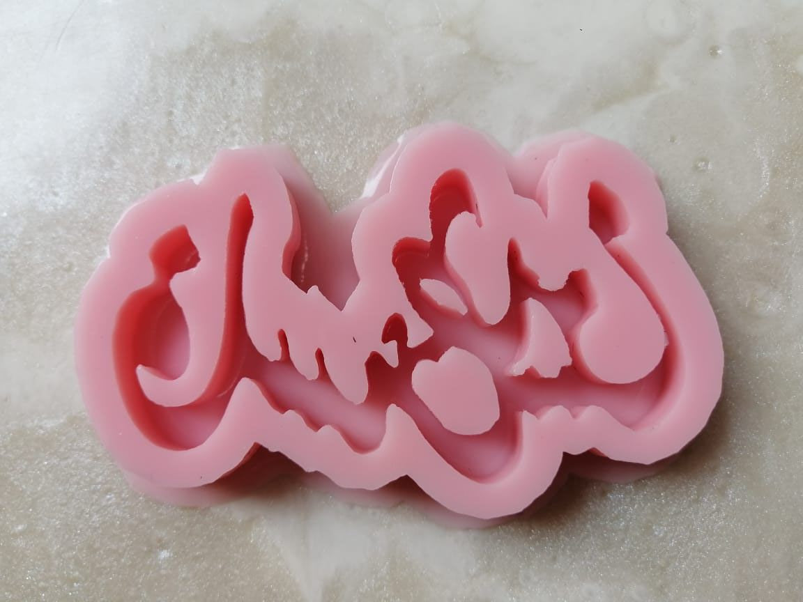 A shiny pink silicone mold forming the word Palestine, composed of interlocking engraved letters.