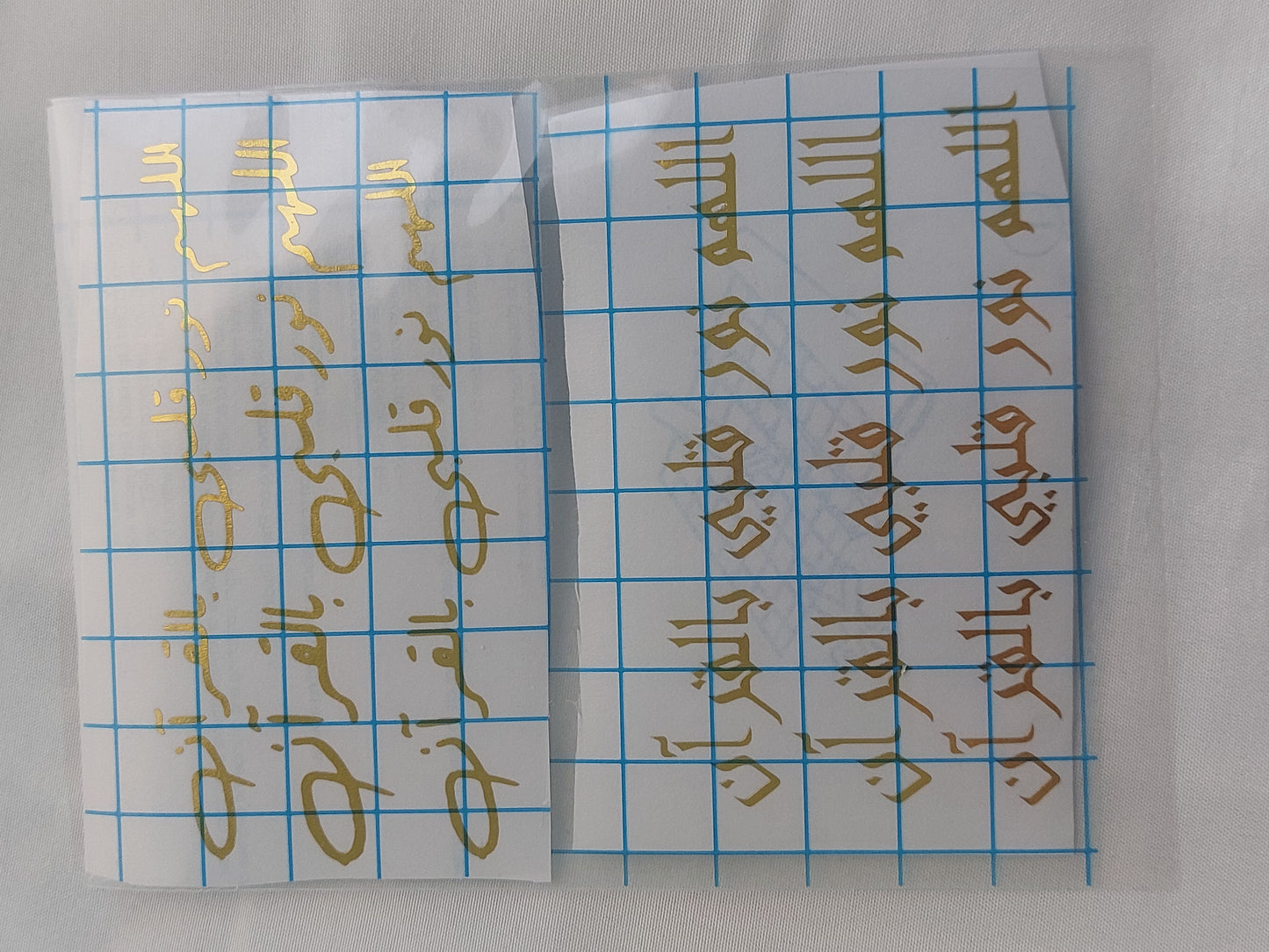 Vinyl, transparent printed paper, or stickers containing prayers. This type of repeated text is used to be placed inside the provided resin molds, or to be glued onto car pendants and medals as handicrafts